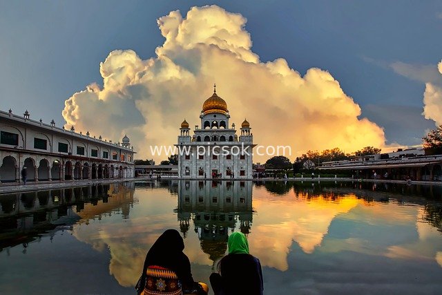 Nanak Piao Gurudwara in Delhi: Golden Dome Reflecting on Clear Water, Dusk Clouds