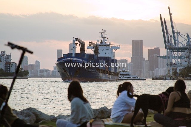 Sunset at Miami Beach: Seaside Moments with Container Ships and Leisure Crowds