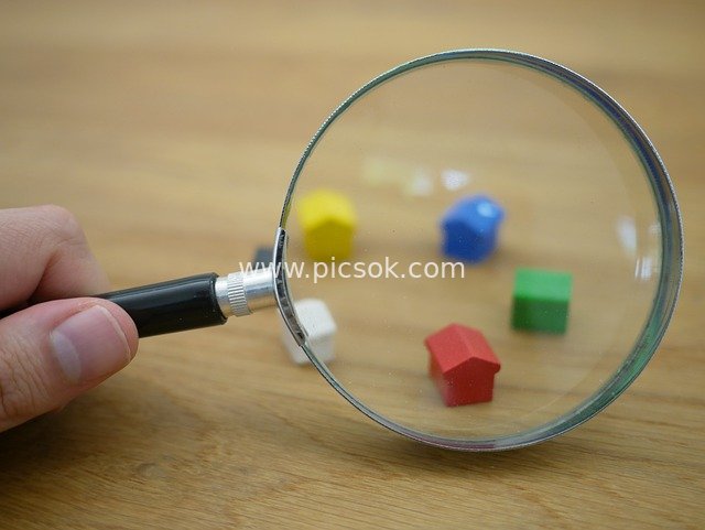 Colorful Mini Houses Under a Magnifying Glass - Creative Asset for Property Search