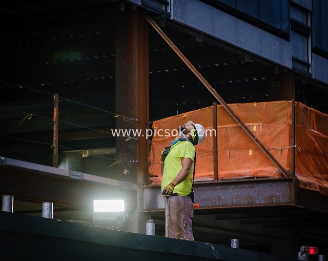 Real Shot of Construction Workers Wearing Safety Helmets Working on Construction Site