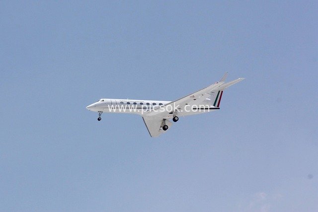 Gulfstream G550 Business Jet Taking Off with Mexican Livery Against Blue Sky