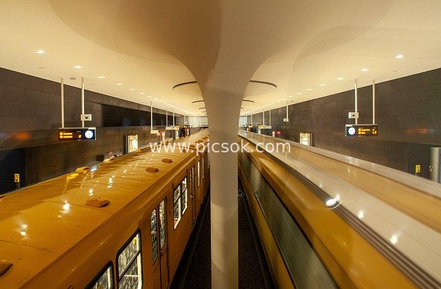 Scene of Yellow Trains Stopped at Platforms in a Modern Subway Station