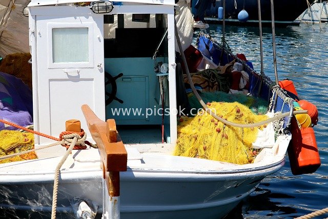 Close-up of Traditional Fishing Boat and Yellow Fishing Nets at Greek Fishing Port