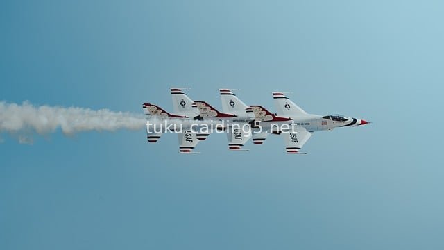 US Air Force Jet Fighters Performing Formation Aerobatics in the Blue Sky