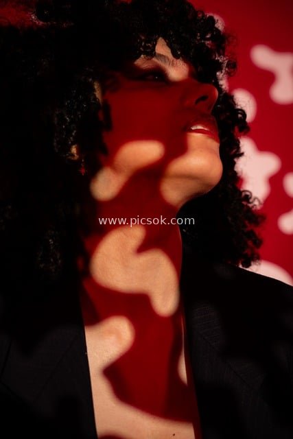 Artistic Portrait: Stylish Woman with Curly Hair & Red Light & Shadow