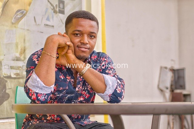 Portrait of an African Man in Casual Sitting Posture Wearing a Fashionable Floral Shirt