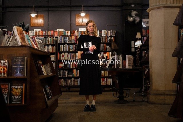 Young Girl Holding a Black-and-White Image in Los Angeles' Last Bookstore