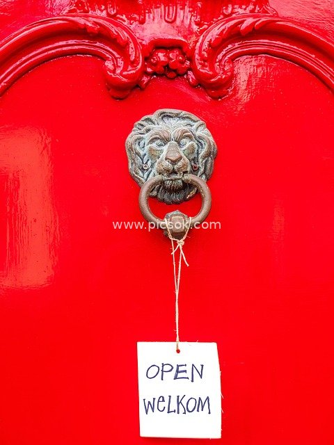 Red Gate with Lion Door Knocker and Welcome Sign – Retro Entrance