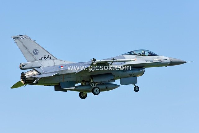 Royal Netherlands Air Force F-16 Fighter Jet in Flight Against Blue Sky