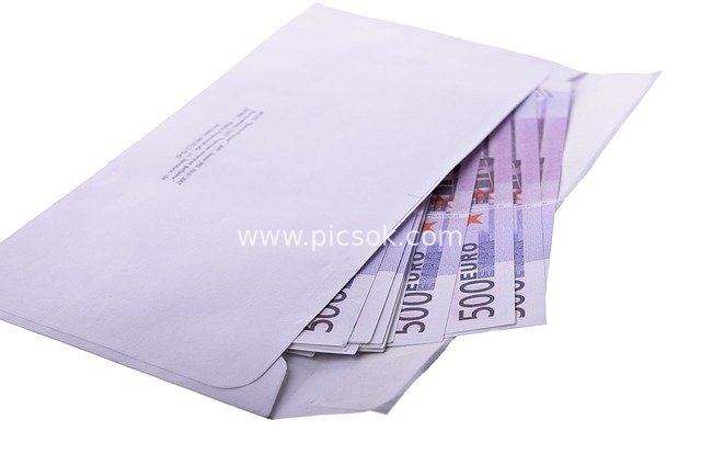 Business Material: 500 Euro Cash Peeking Out of a White Envelope