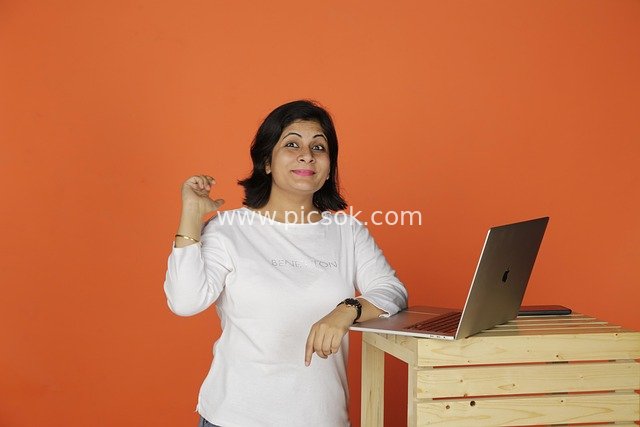 Professional Woman Thinking About Work Creativity in Office Scene with Laptop