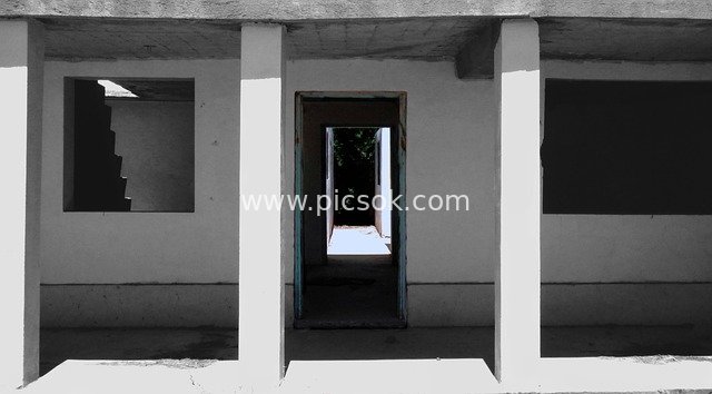 Abandoned Residential Corridor: Desolate Architectural Landscape in Black, White and Gray Tones