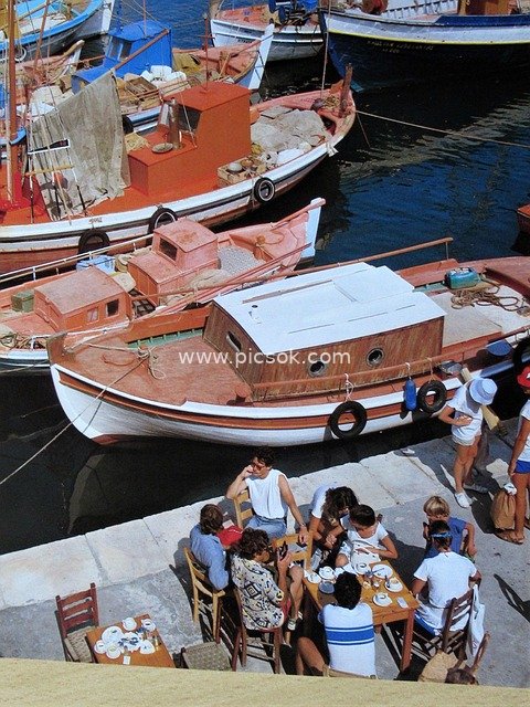 Greek Harbor: Cozy Gathering Beside Fishing Boats