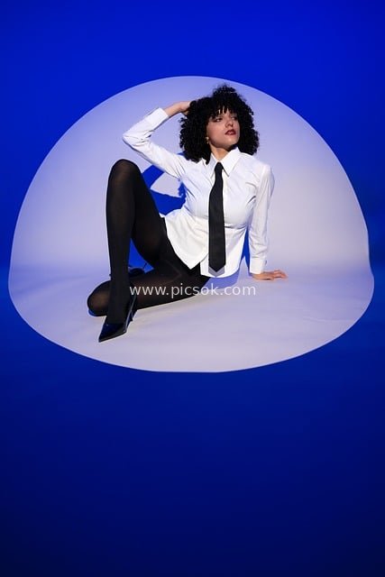 Fashion Model Artistic Portrait: White Shirt with Black Tie & Elegant Pose Against Blue-White Background