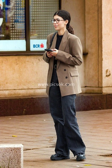 Urban Street: Young Woman with Glasses Relaxedly Waiting and Checking Phone