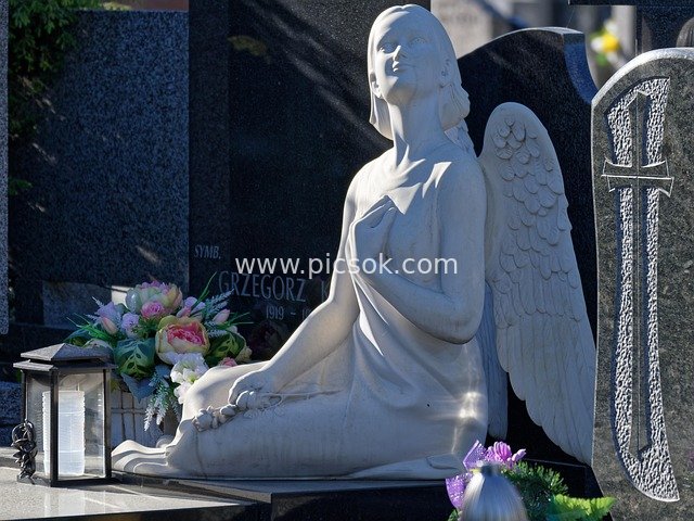 Serene Scene of Angel Sculpture, Tombstones and Flowers in a Cemetery