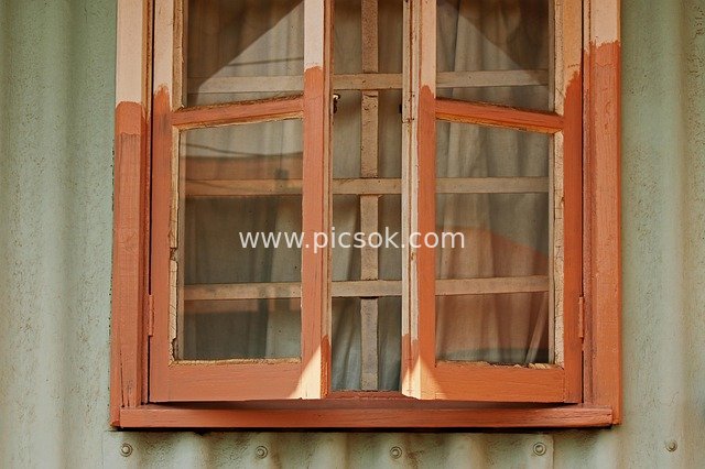 Restoration of an Old Wooden Window in a Corrugated Iron Wall Building Repair Scene