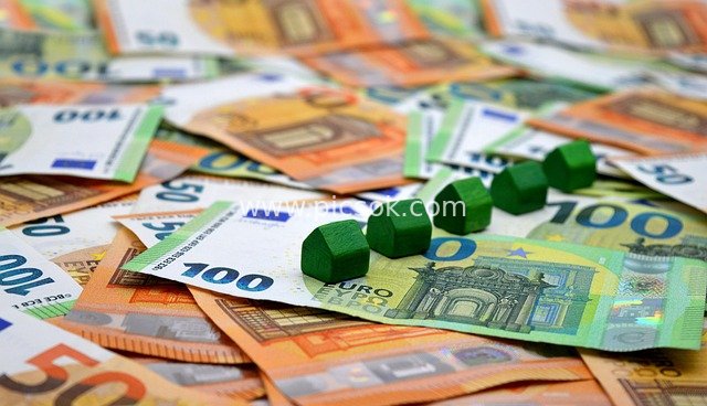 Stack of Euro Banknotes with Green Dice - Real Estate Financing & Housing Construction Capital Material