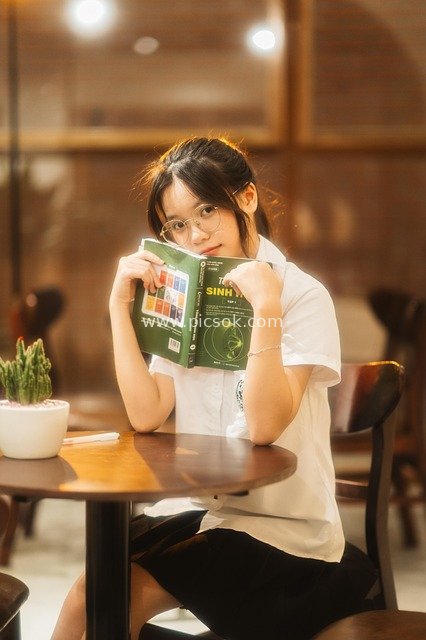 Adorable Asian Girl Studying in a Café - Student Portrait Photo