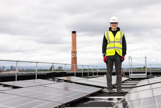 Young Apprentice Inspecting Solar PV Panels on an Urban Rooftop: Professional Scene