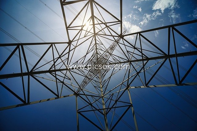 High-Voltage Power Tower & Electrical Infrastructure in Blue Sky and Sunlight
