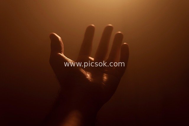 Praying Hands in Warm Halo: Symbol of Spiritual Faith and Healing
