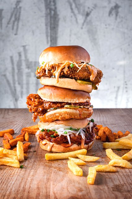 Triple-Layer Spicy Fried Chicken Burger with Fries - Tempting Fast Food Delight