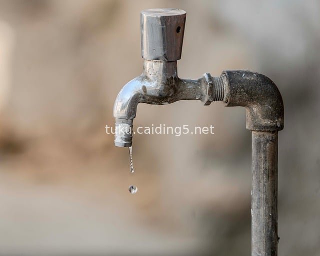 Close-up of a Leaking Old Metal Faucet with Suspended Water Droplets