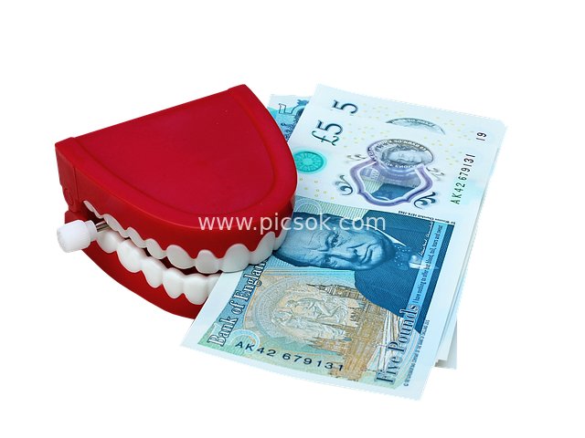 Creative Scene: Red Toy Tooth Pressing British Pound Banknotes