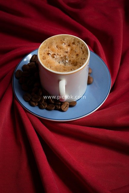 Hot Coffee Cup, Coffee Beans, and Coffee Drink on Red Velvet Background
