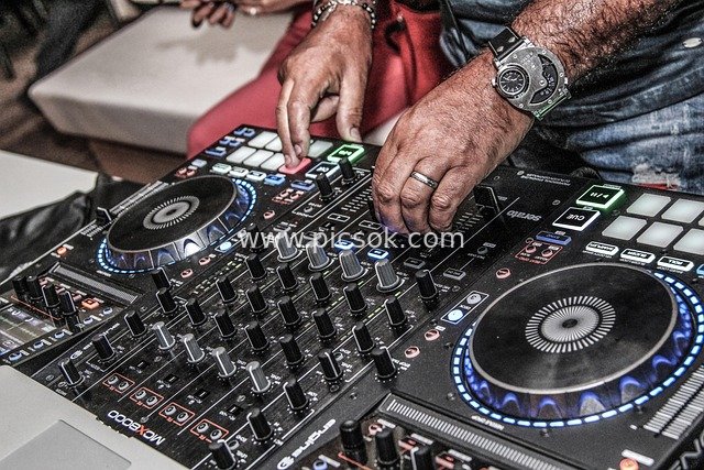 Professional DJ Operating Mixer in Live Music Production Scene