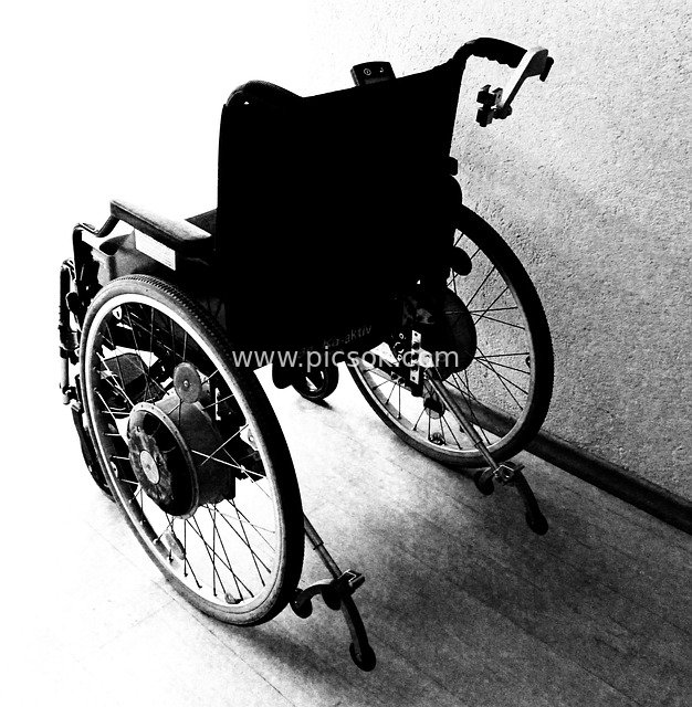 Black and White Photography: Electric Wheelchair Against the Wall - Disability Assistive Device Material