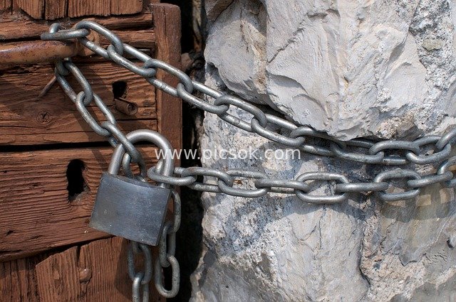 Secure Entrance Scene with Padlocked Metal Chain, Wooden & Stone Structures