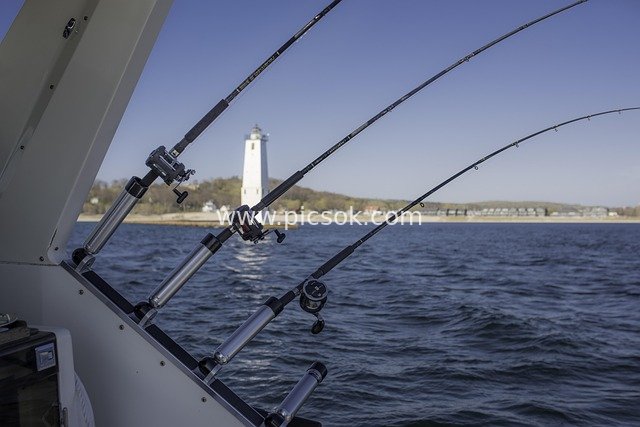 Fishing Rods on Yacht Side: Coastal Lighthouse & Sea Fishing Scenery