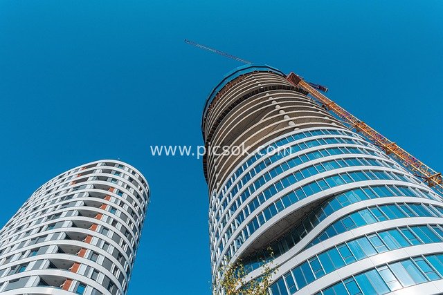 Modern High-Rise Buildings Against Blue Sky: Urban Landmark Under Construction