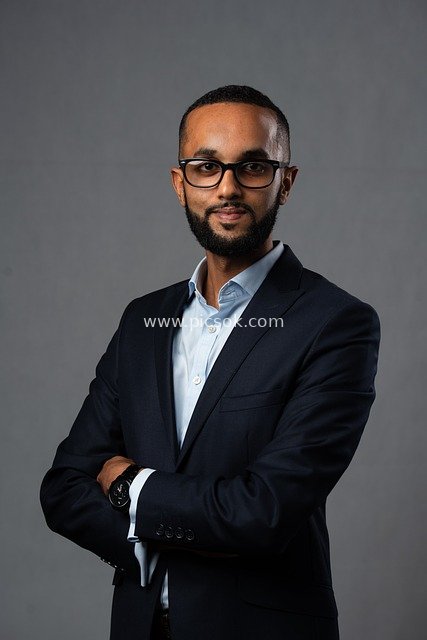 Portrait of a Confident Businessman in Formal Attire with Crossed Arms (Professional Workplace Image)