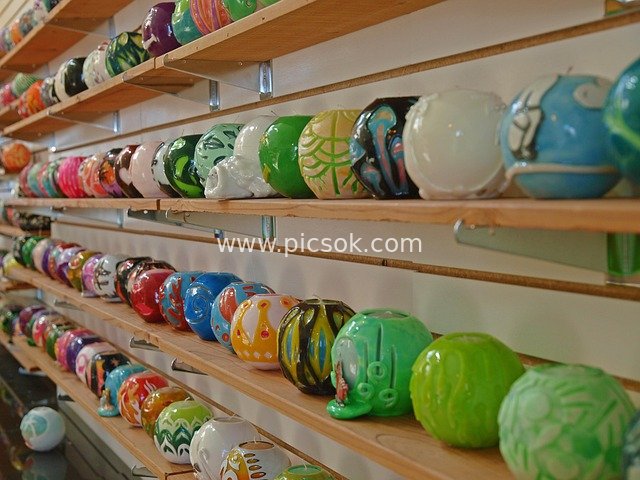 Colorful Handmade Decorative Balls Displayed on Wooden Shelves