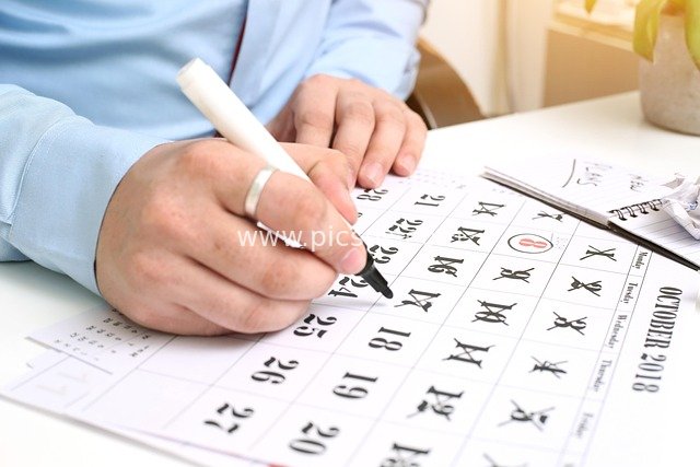 Close-up of Handwritten Schedule & Date Marking on Business Office Calendar
