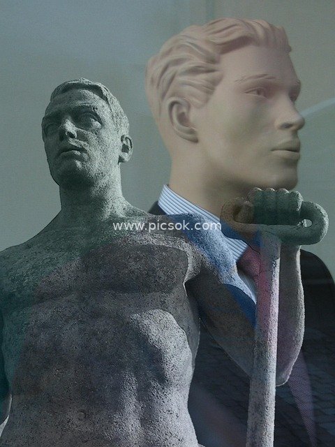 Labor Contrast Scene: Stone Worker Statue vs Suit-clad Puppet