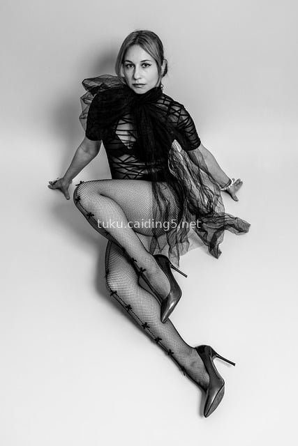 Sexy Posing of Fashion Female Model in Sheer Tulle Bodysuit & Fishnet Stockings