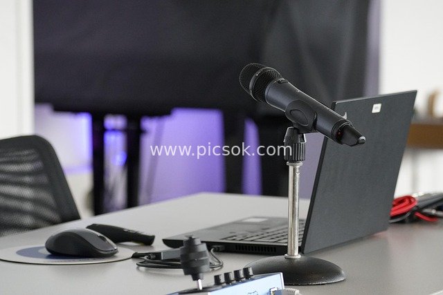 Microphone and Laptop on Office Conference Table