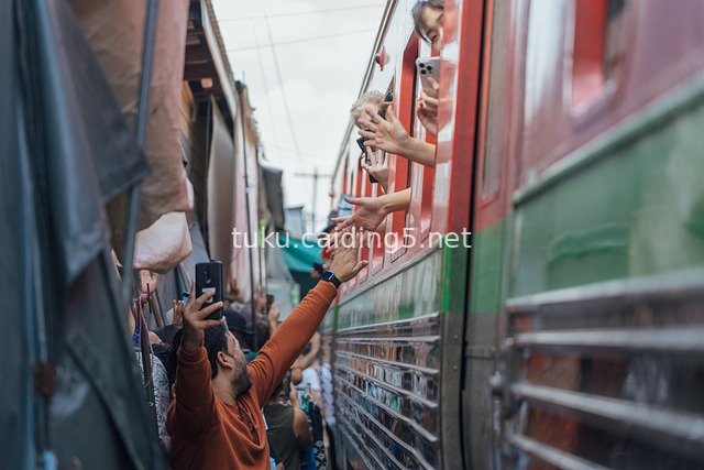 Friendly Interaction by Thai Train: Warm High-Five Moment During Travel