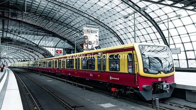 Commuting Scene at Berlin Subway Station with Red-Yellow Train