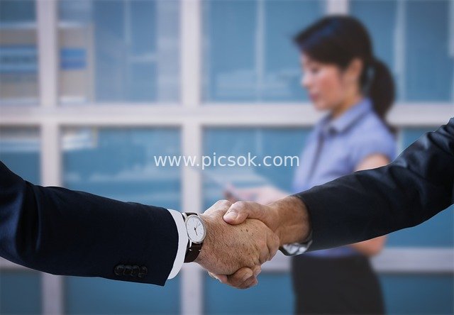 Business Handshake Collaboration in Workplace: Win-Win Teamwork Scene