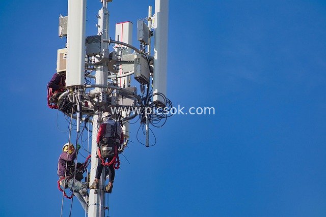 High-Altitude Workers Installing Antennas on Communication Base Station Towers