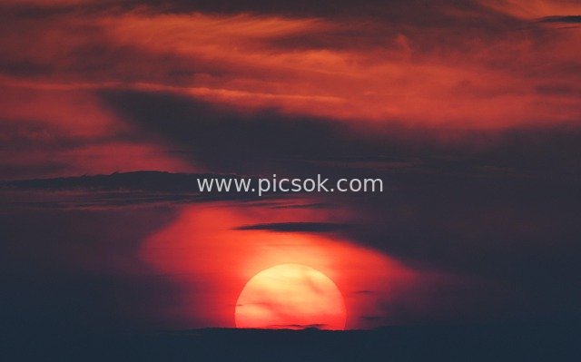 Vibrant Sunset Glow at Summer Dusk, Red Sun Sinking in Beautiful Sky