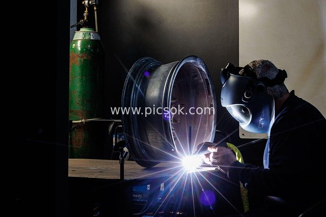 Industrial Welding Repair of Alloy Wheel Rims: Workshop Metalworking Scene