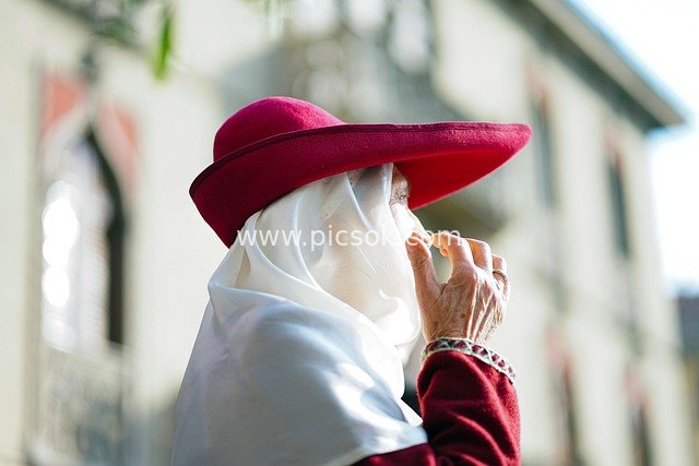 Portrait of a Woman Wearing a Red Hat at the Forgiveness Festival Celebration