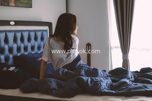 Woman Relaxing in Bedroom: Cozy Home Scene