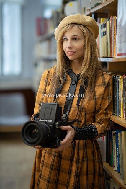 Vintage Female Photographer Holding a Mamiya Camera in the Library